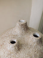 Close view of the three spouts and rough textured surface of the Amit terracotta vessel