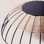 Cabo handwoven rattan basket upside down to show details by calmly elevated