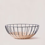 Cabo rattan basket empty showing natural weave and powder-coated frame — Calmly Elevated