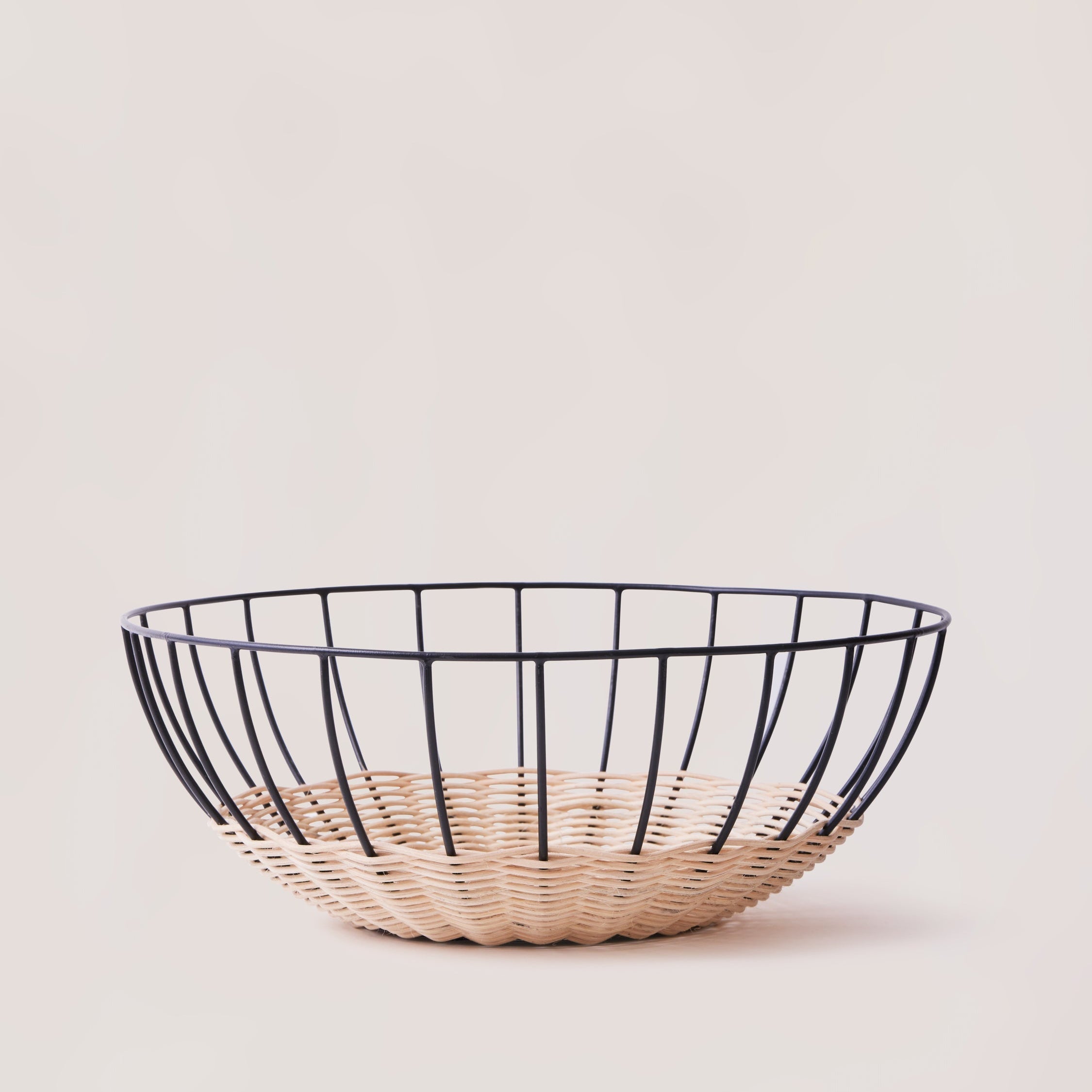 Cabo rattan basket empty showing natural weave and powder-coated frame — Calmly Elevated
