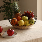 Cabo rattan fruit basket styled on dining table as centerpiece — Calmly Elevated