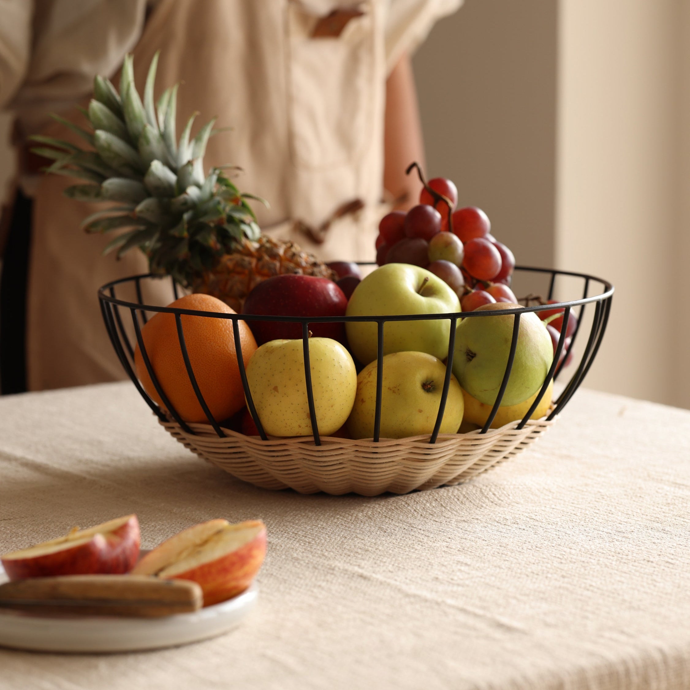 Cabo rattan fruit basket styled on dining table as centerpiece by Calmly Elevated