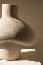 Cream terracotta sculptural vase with rounded hut like silhouette and matte finish