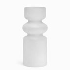 Frosted glass bud vase with rounded symmetrical tiers on a pale backdrop