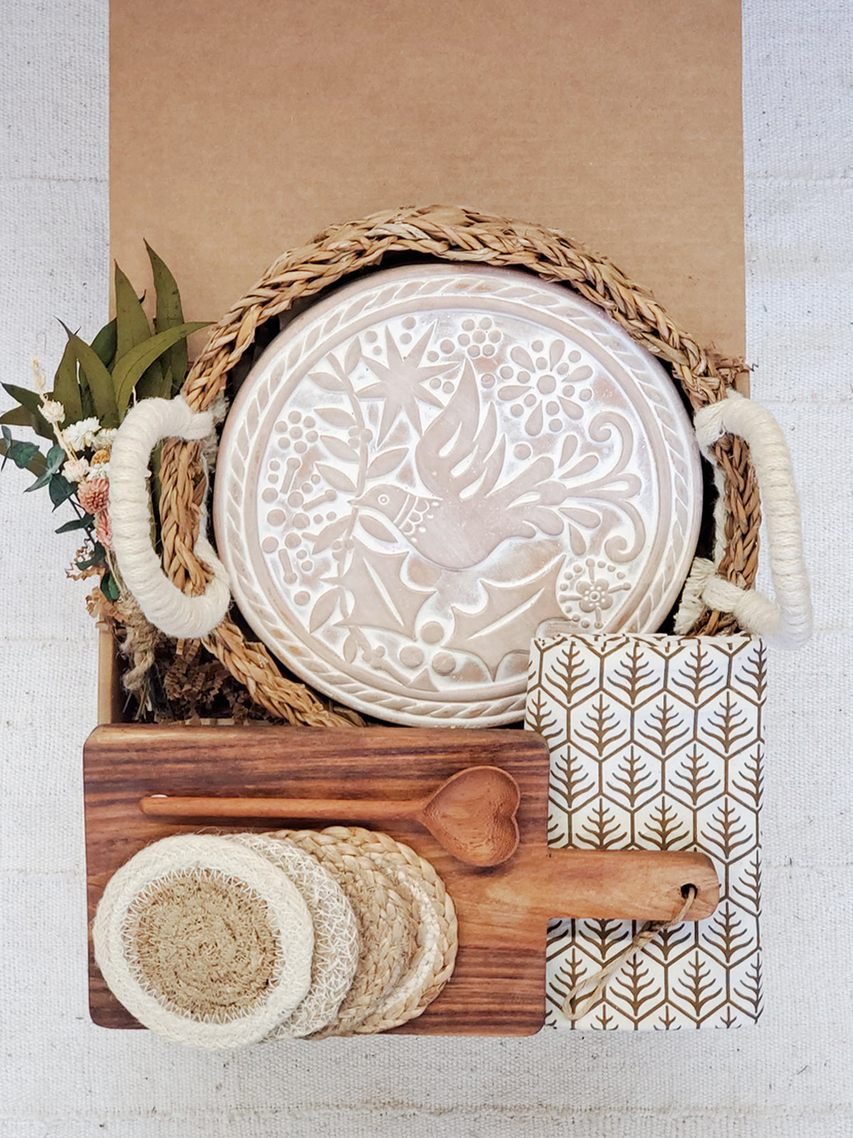 Hand-engraved terracotta bread warmer round on acacia board, dark tea towel — Calmly Elevated