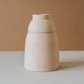 Handcrafted Chubby vase by Al Centro with a rounded stepped body in light terracotta on a stone surface