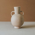 Handcrafted Tirreno amphora vase with two side handles in light terracotta on a stone surface
