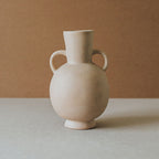 Handcrafted Tirreno amphora vase with two side handles in light terracotta on a stone surface