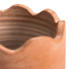 Large wavy terracotta planter close-up showing organic curves and natural clay texture — Calmly Elevated
