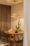 Lotus Rattan Pendant Light hanging above coffee table