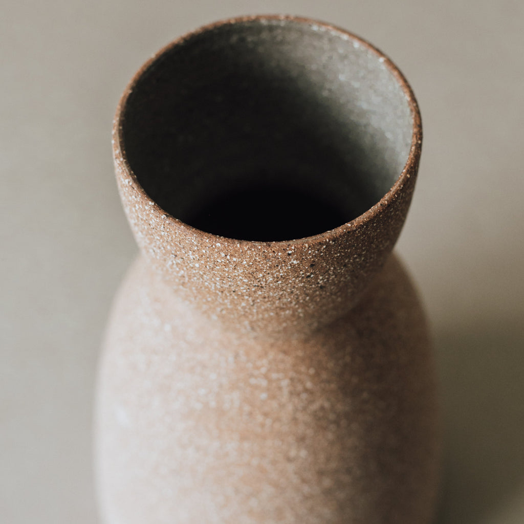 Reloj vase showing its wide flared mouth and dark glazed interior