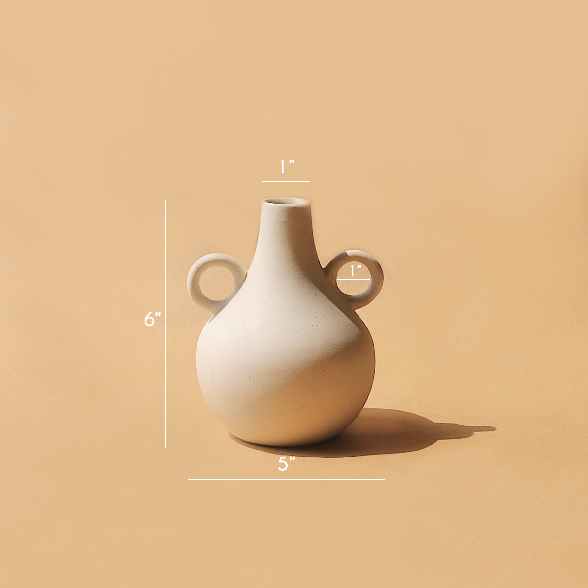 Tan Harappan jug vase with measurement markings on a tan backdrop