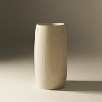 Tapered natural wood vase showing visible timber grain on a neutral background