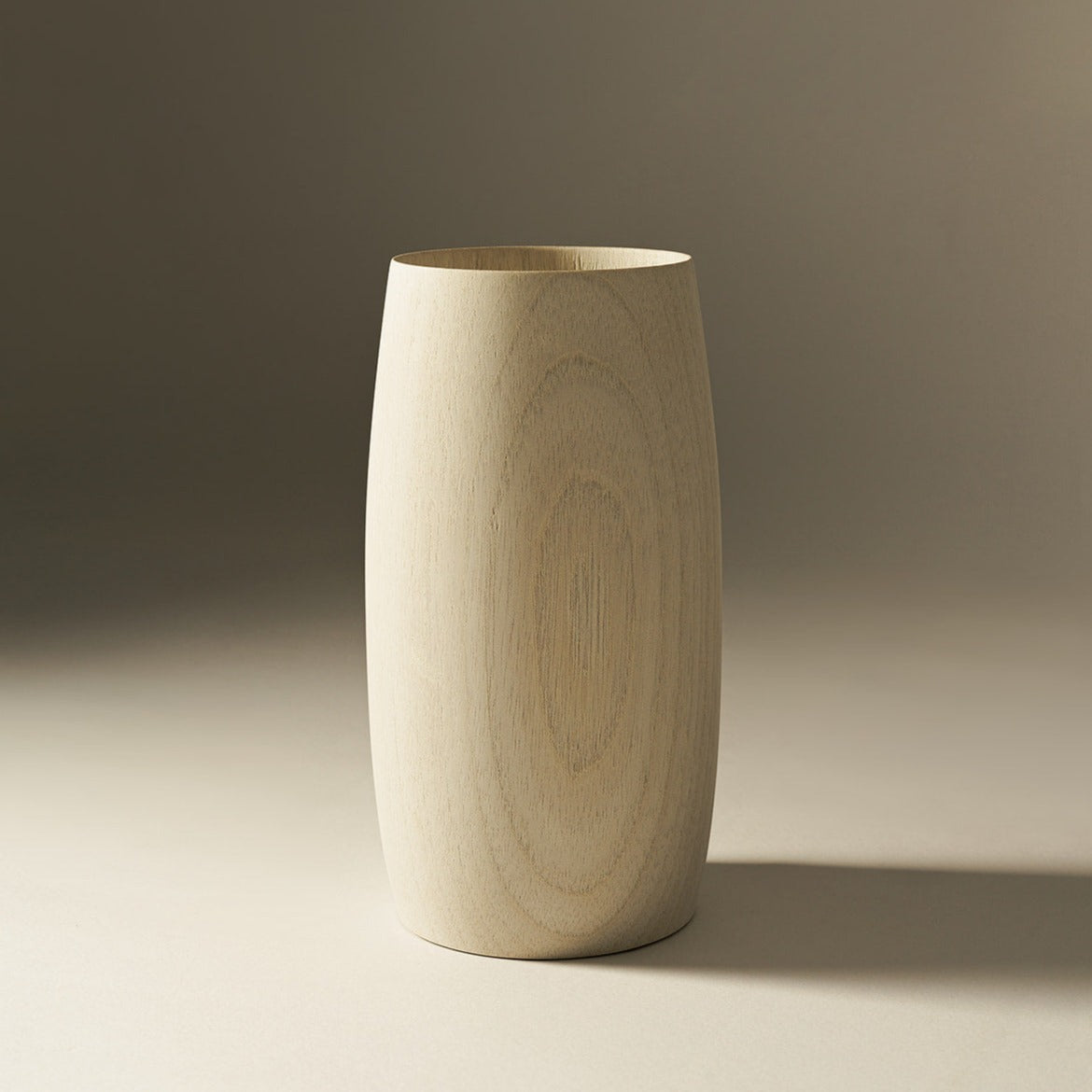 Tapered natural wood vase showing visible timber grain on a neutral background