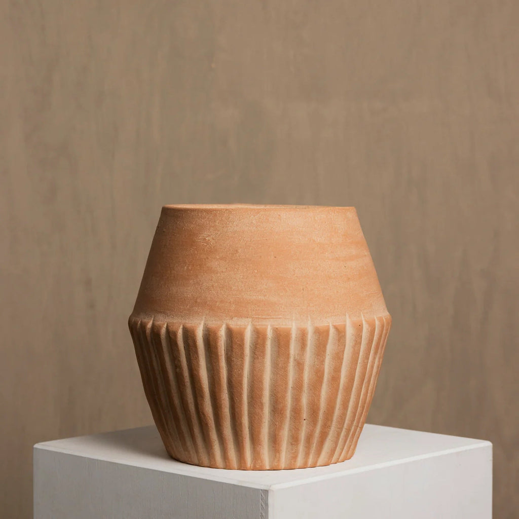 Valentina terracotta planter styled on floor in home interior — Calmly Elevated