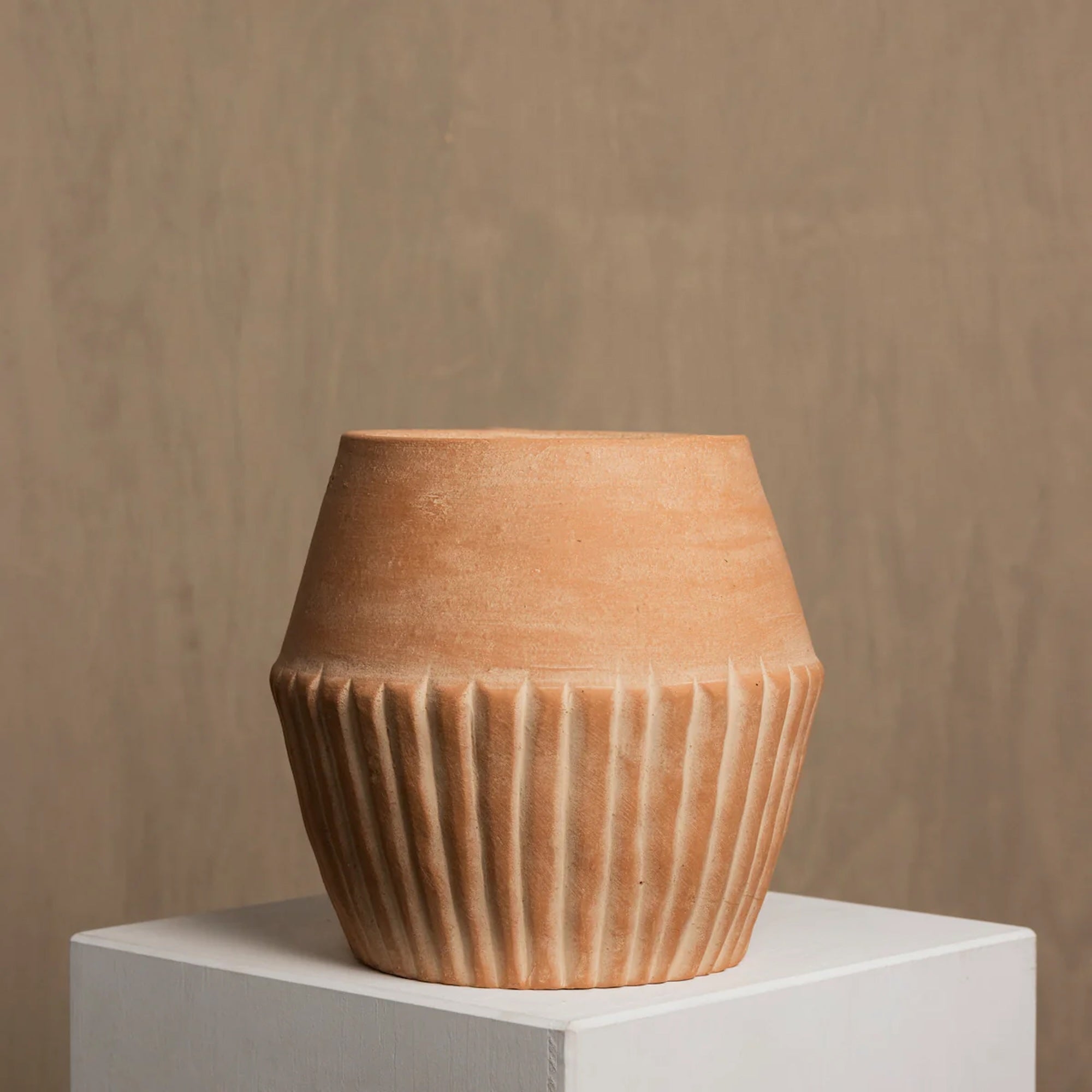 Valentina terracotta planter styled on floor in home interior — Calmly Elevated