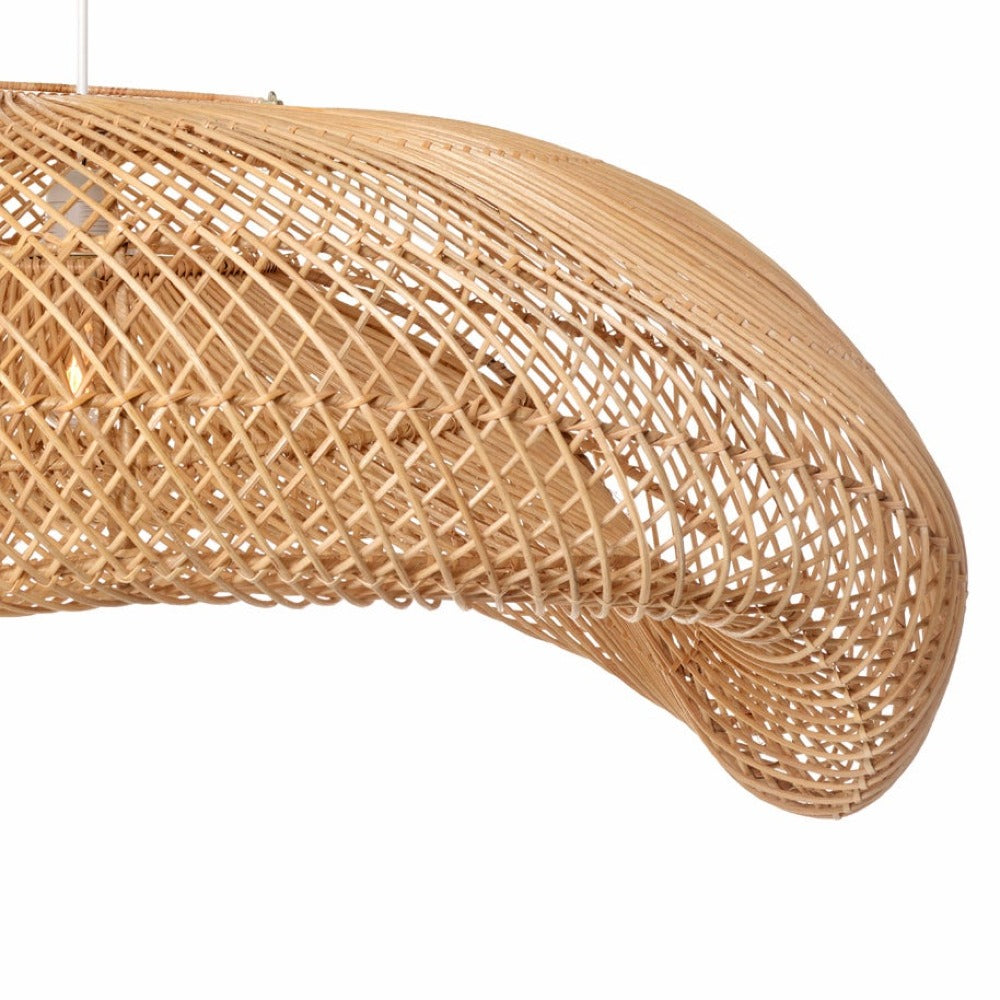 Elongated woven rattan pendant shade showing its gentle arched wave shape
